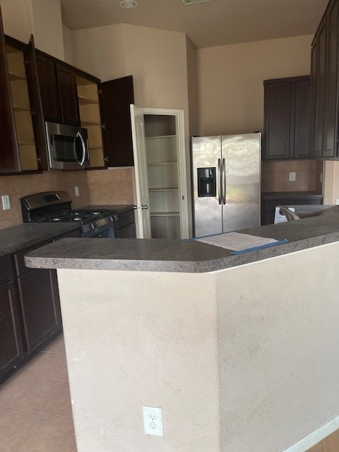 21418 Forest Colony Drive Porter, TX 77365 - Photo 11 of 21 a kitchen with stainless steel appliances granite countertop a sink and a stove top oven with wooden floor