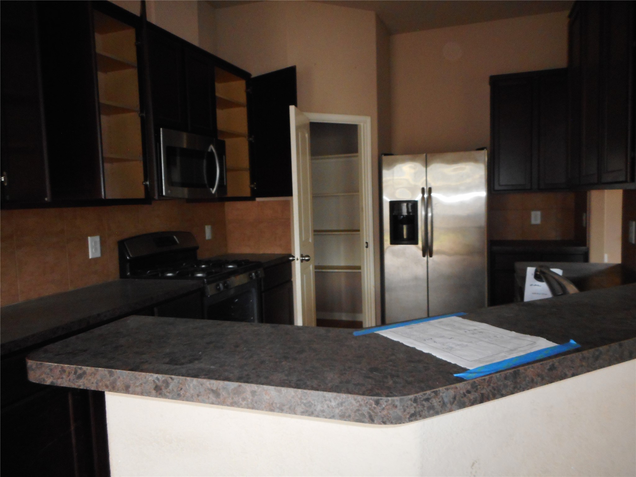 21418 Forest Colony Drive Porter, TX 77365 - Photo 5 of 21 a kitchen with a refrigerator sink and stove