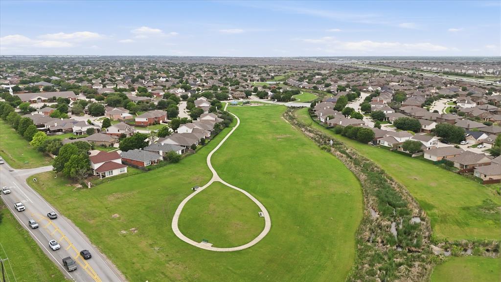 11500 Starlight Ranch Fort Worth, TX 76052 - Photo 39 of 40 Aerial view showcasing a residential area with a prominent green space featuring a walking path and mature trees