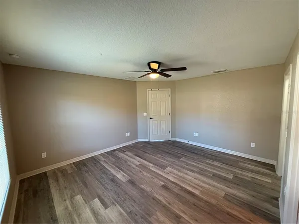 a view of room with wooden floor