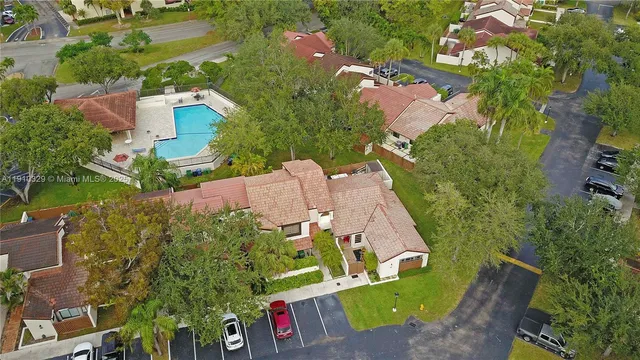an aerial view of a house with a garden and trees