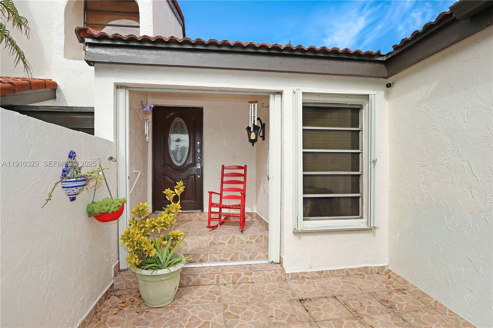 12305 Southwest 94th Terrace Miami, FL 33186 - Photo 2 of 29 a front view of a house with lots of flowers
