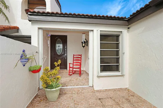 a front view of a house with lots of flowers