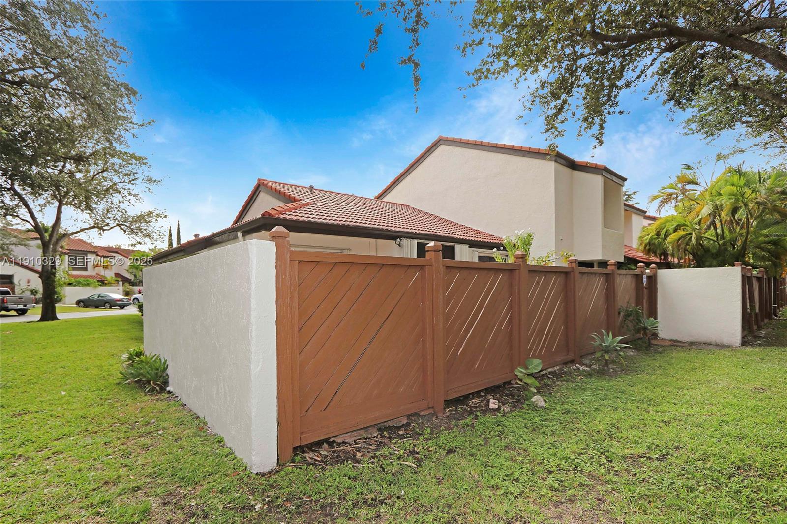 12305 Southwest 94th Terrace Miami, FL 33186 - Photo 26 of 29 a backyard of a house with a small yard and large trees