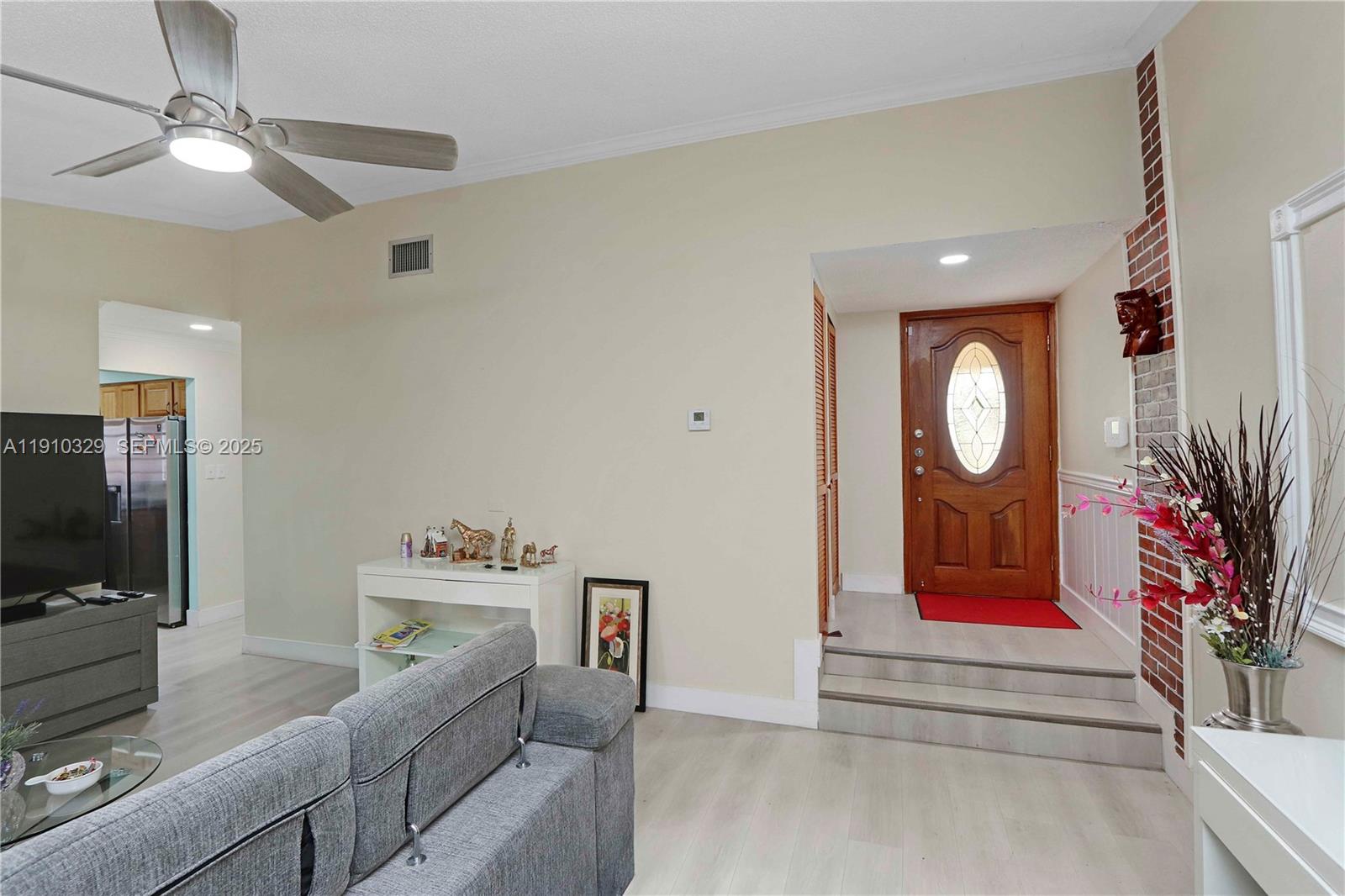 12305 Southwest 94th Terrace Miami, FL 33186 - Photo 3 of 29 a living room with furniture and a flat screen tv