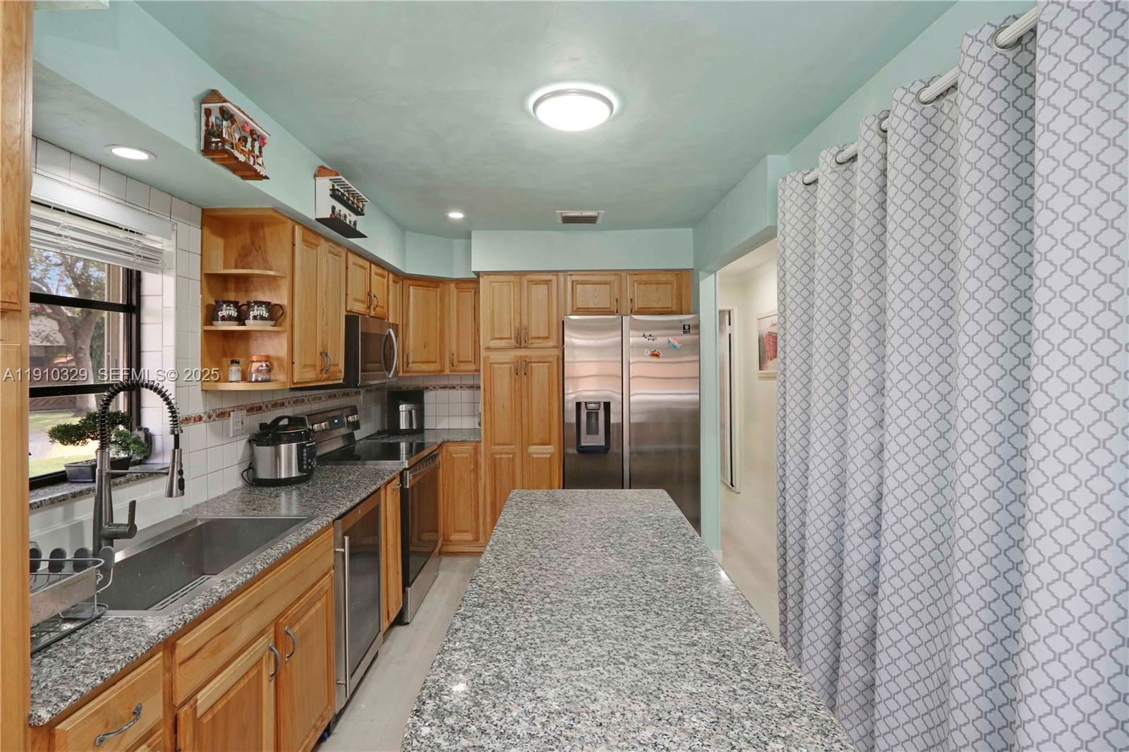 12305 Southwest 94th Terrace Miami, FL 33186 - Photo 6 of 29 a kitchen with stainless steel appliances granite countertop a refrigerator and a sink