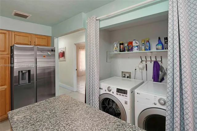 a view of kitchen with refrigerator and washer