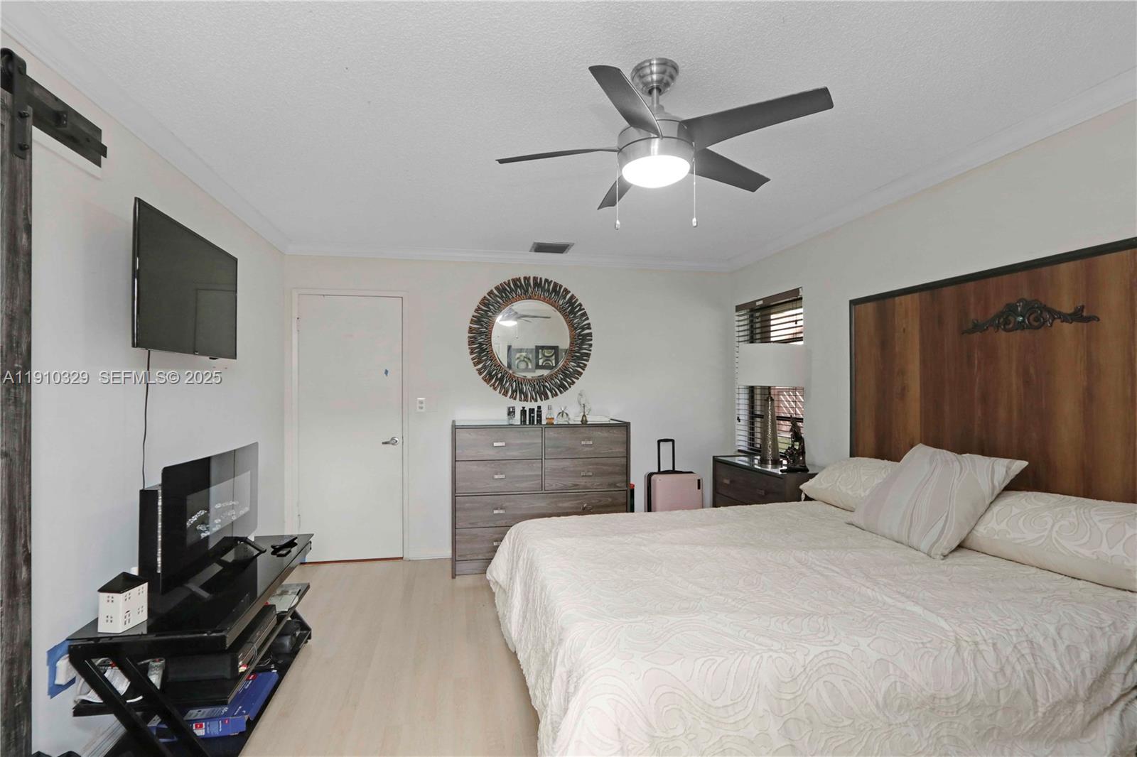 12305 Southwest 94th Terrace Miami, FL 33186 - Photo 8 of 29 a bedroom with a bed a flat screen tv and a large window