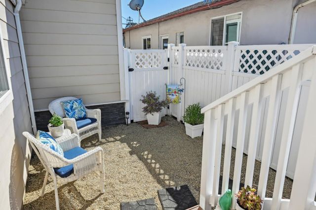 a backyard of a house with table and chairs