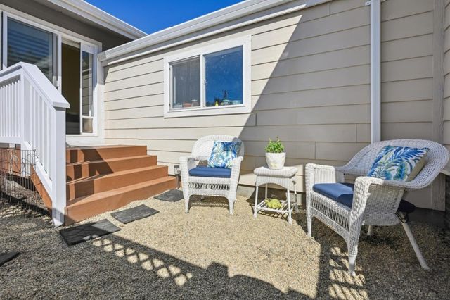 a couple of chairs sitting in front of a house
