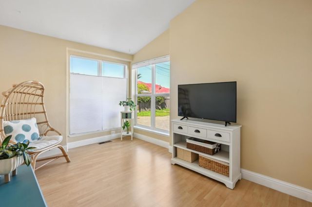 a living room with furniture and flat screen tv