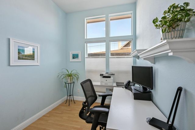 a view of a workspace with furniture and a potted plant