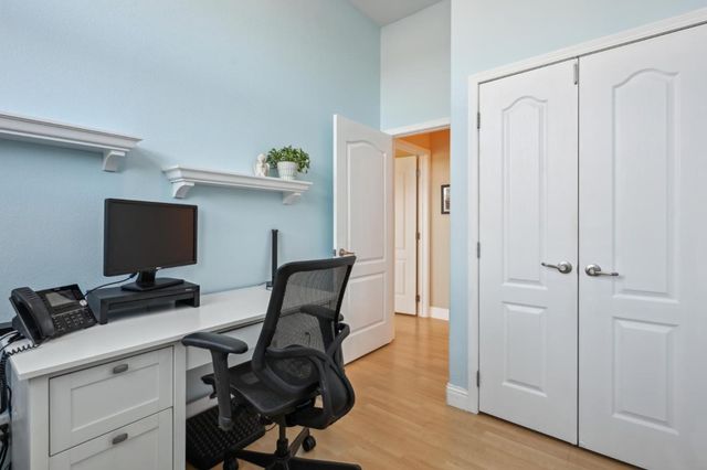 a view of a workspace with furniture and wooden floor