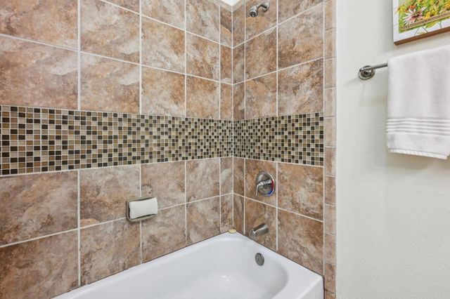 a bathroom with a bathtub and shower