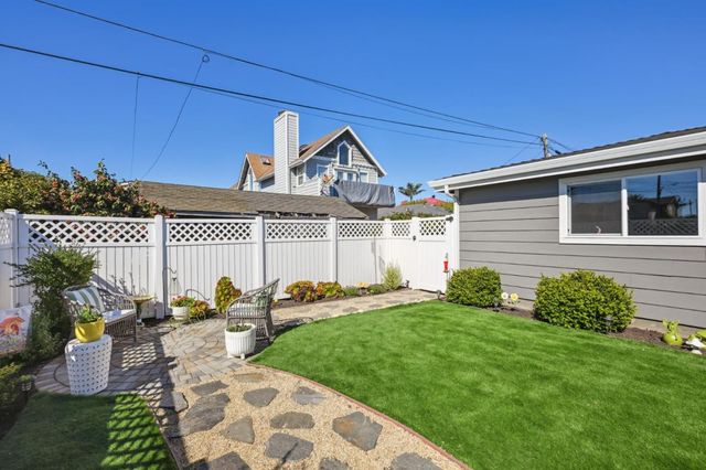 a view of a patio with table and chairs potted plants