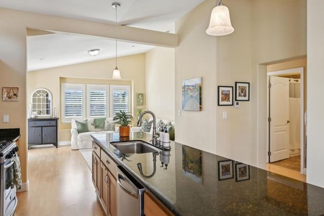 a kitchen with stainless steel appliances granite countertop a sink stove and cabinets