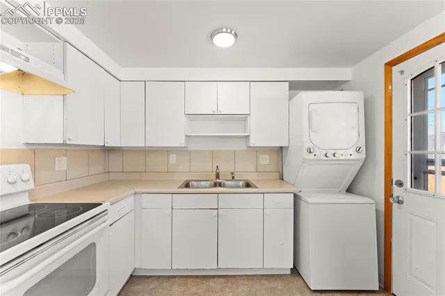 a kitchen with a sink a stove and cabinets