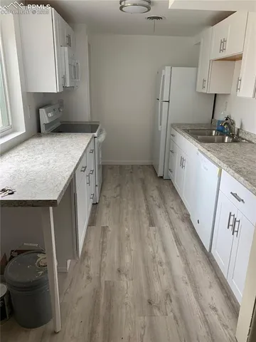 a kitchen with a sink stove and cabinets