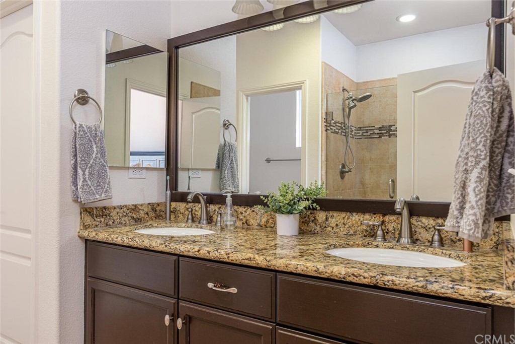 1039 Ford Drive Nipomo, CA 93444 - Photo 17 of 45 a bathroom with a granite countertop sink and a mirror