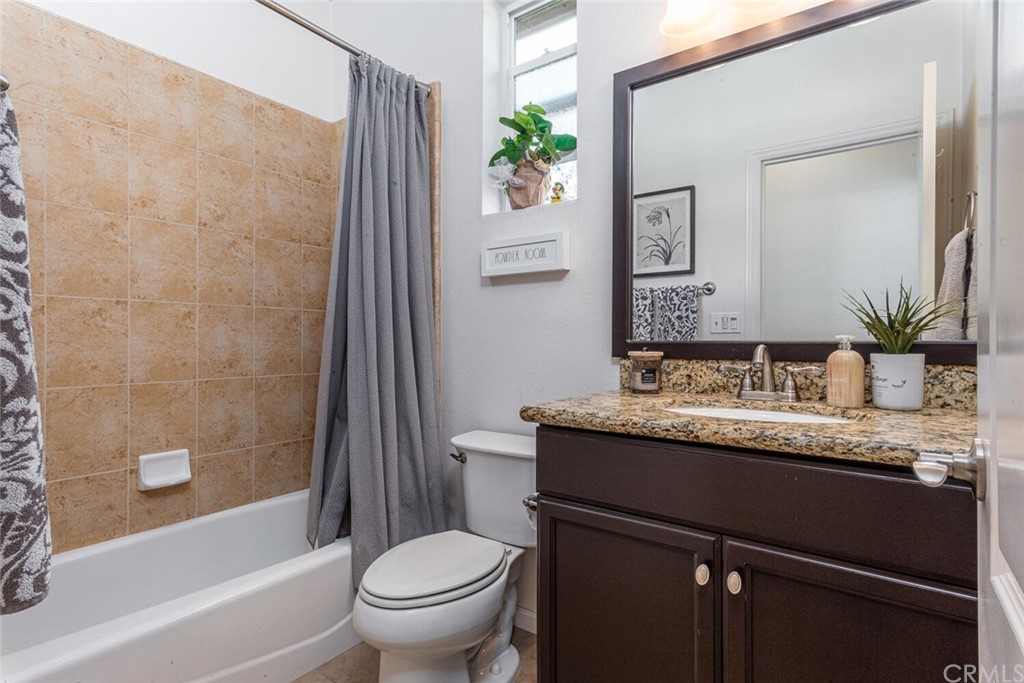 1039 Ford Drive Nipomo, CA 93444 - Photo 22 of 45 a bathroom with a granite countertop sink toilet and shower