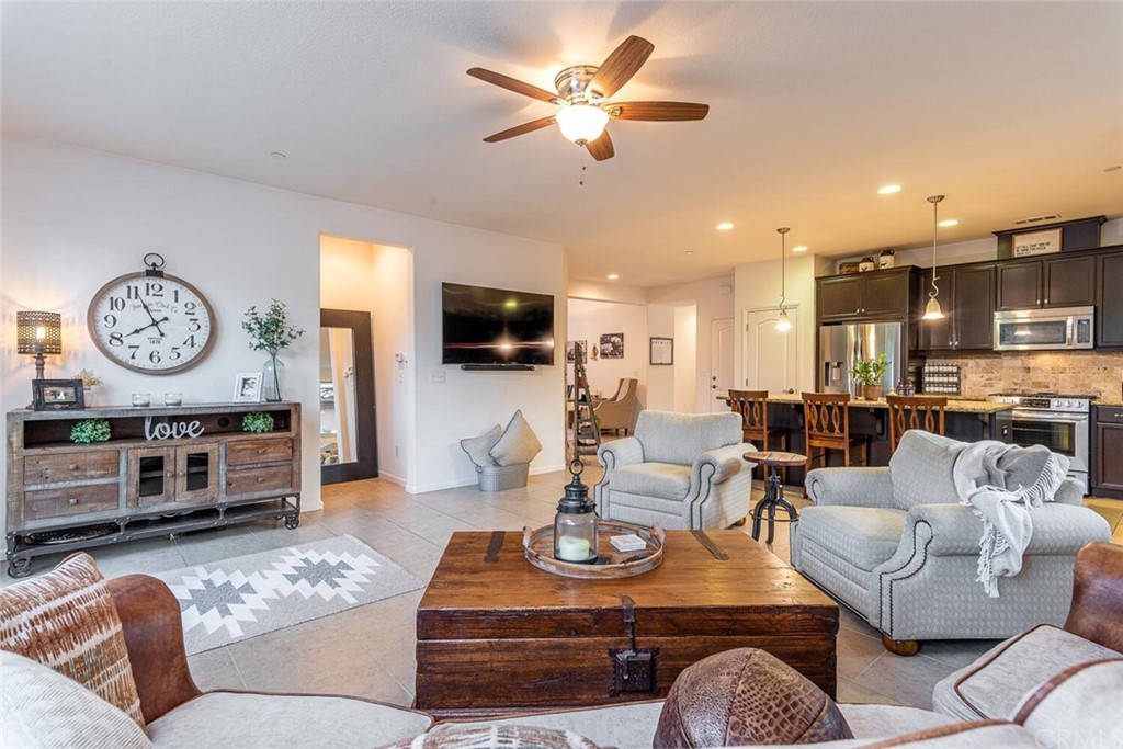 1039 Ford Drive Nipomo, CA 93444 - Photo 9 of 45 a living room with furniture a clock and a flat screen tv