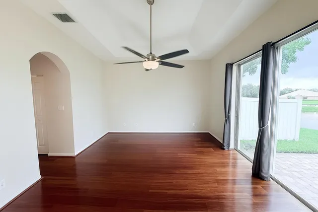 a view of a livingroom with a ceiling fan and wooden floor