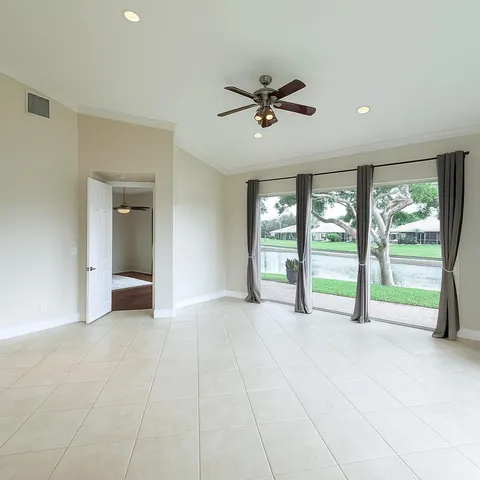 a view of an empty room with glass door