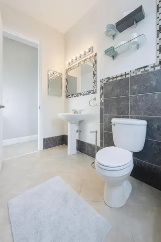 a bathroom with a toilet a sink and bathtub