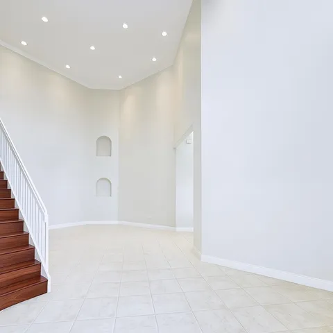 a view of an empty room with stairs