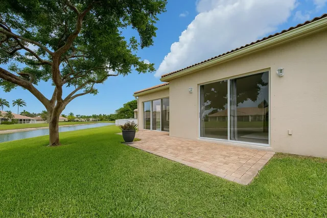 a view of a house with a yard and tree