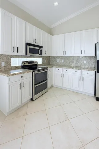 a kitchen with cabinets and appliances