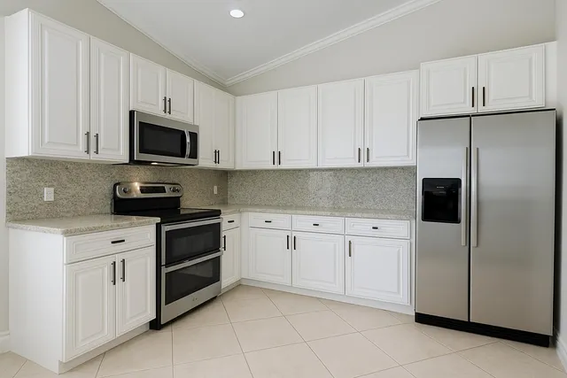 a kitchen with cabinets stainless steel appliances and a sink