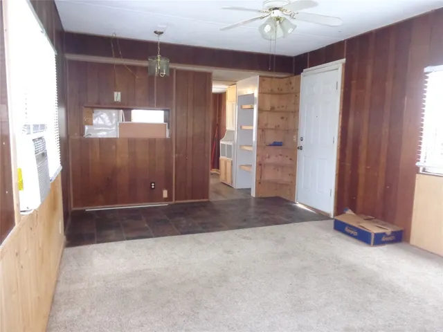 an empty room with closet and windows