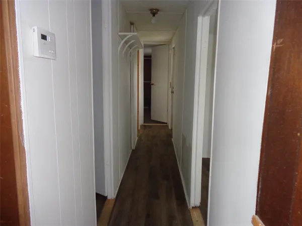 a view of a hallway with a wooden door