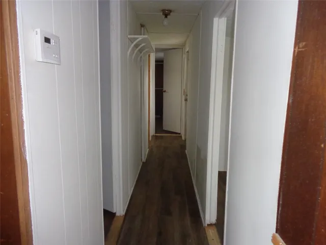 a view of a hallway with a wooden door