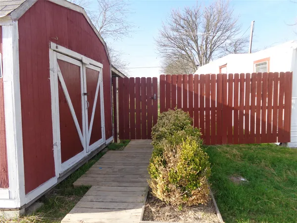 a view of a backyard with wooden fence