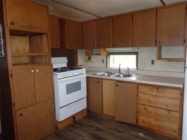 a kitchen with appliances cabinets and a sink