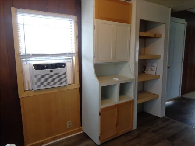 a kitchen with white cabinets and a sink