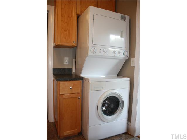 901 North State Street Raleigh, NC 27604 - Photo 8 of 21 The stacking front loading washer and dryer also convey and are located in the kitchen. The seller maximized the storage space by surrounding them with cabinets and extra counterspace.