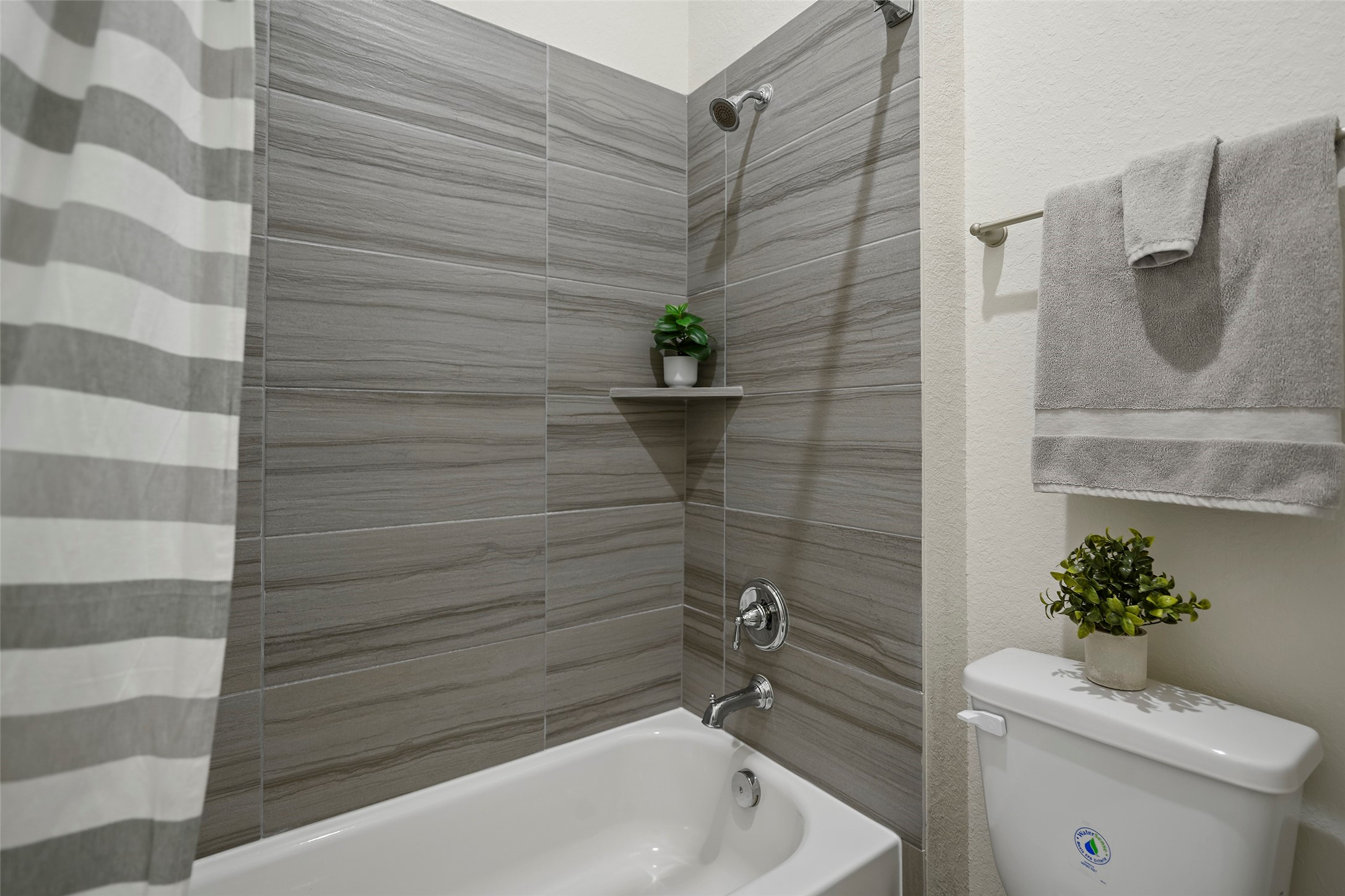 20330 Rosegold Way Spring, TX 77379 - Photo 28 of 48 Tub and shower combination accented by stylish floor-to-ceiling tile surround.