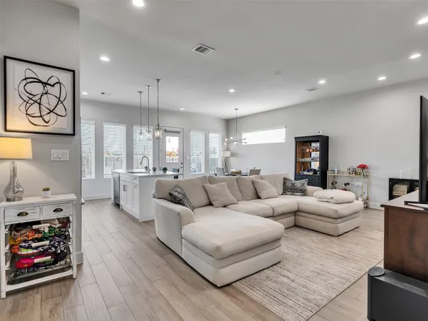 a living room with furniture dining room and wooden floor