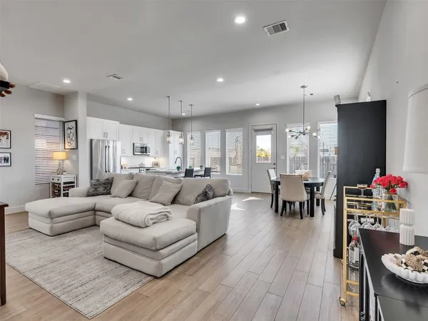 a large kitchen with a table and chairs