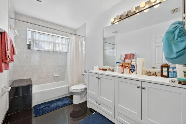 a bathroom with a sink toilet a tub and shower