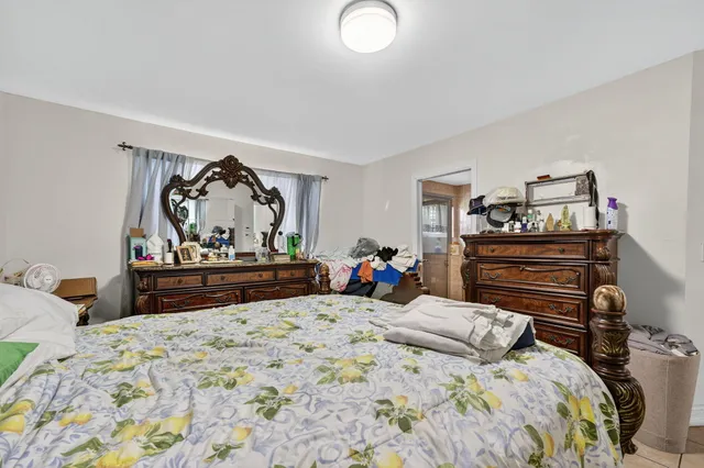 a bedroom with a bed and a dresser in it