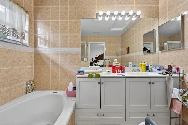 a bathroom with a sink a bath tub and shower
