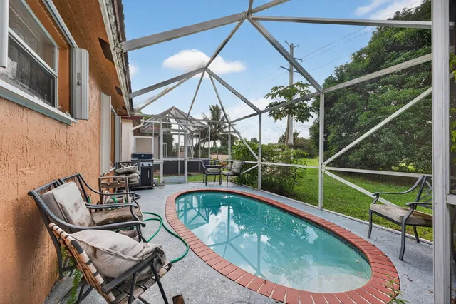 a view of a chair and tables in the balcony