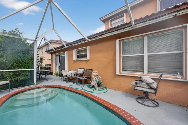 a swimming pool with outdoor seating