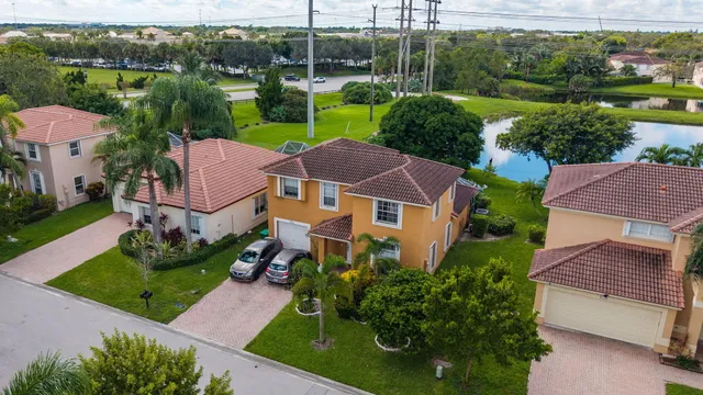 an aerial view of a house with garden space and a lake view