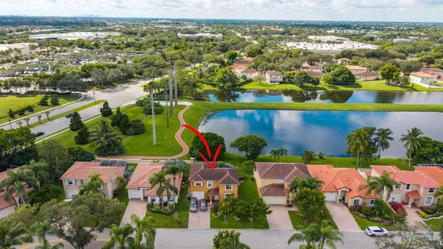 an aerial view of residential building and lake