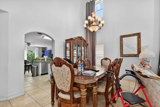 a view of a dining room with furniture and chandelier